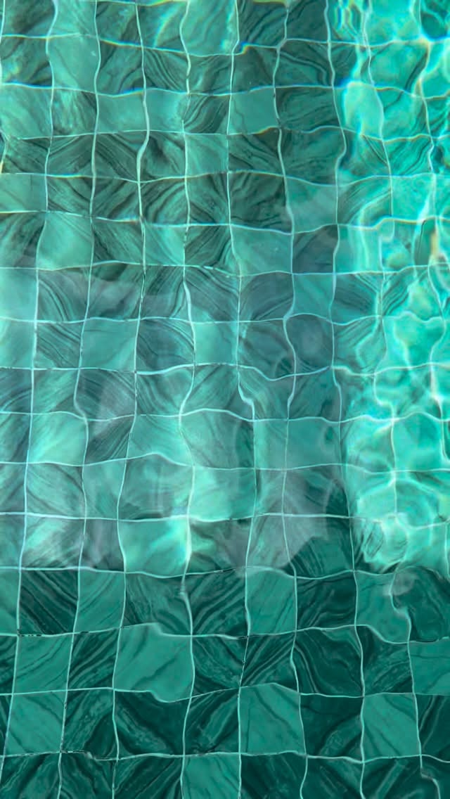 Close-up of villa pool — abstract turquoise and sea glass tiles